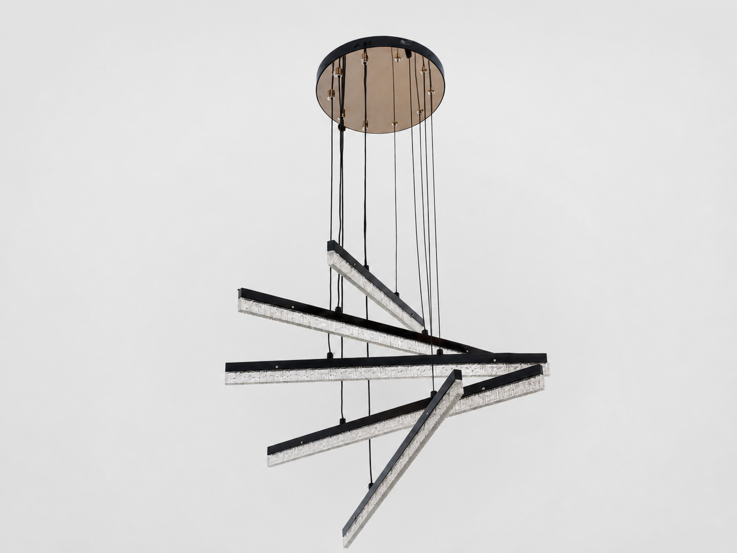 A modern multi-light linear chandelier with black and silver metallic arms, suspended from a circular black ceiling canopy against a plain light gray background.