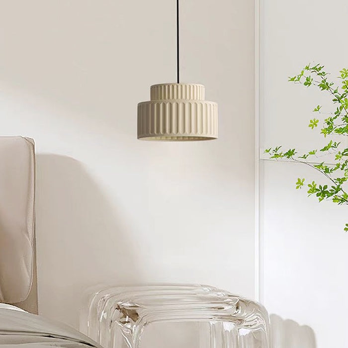 Beige pendant light hanging above a clear glass chair nz