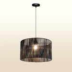 Black pendant light with a cylindrical design hanging on the enrty area