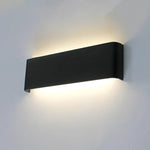 Black wall-mounted light fixture on a gray wall west auckland