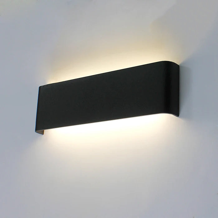 Black wall-mounted light fixture on a gray wall west auckland