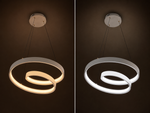 A modern double-ring LED ceiling light shown in a side-by-side comparison of its warm yellow glow on the left and cool white glow on the right, set against a dark brown background.