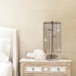 Decorative table lamp with crystal accents on a nightstand next to a bed nz