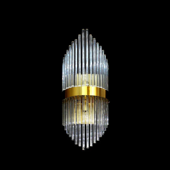 Decorative wall light fixture with clear glass and gold accents on the wall