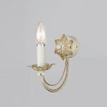 Decorative wall sconce with candle-like light on a gray wall auckland