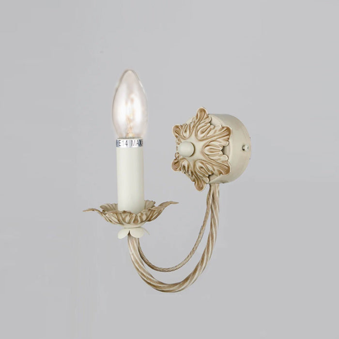 Decorative wall sconce with candle-like light on a gray wall auckland
