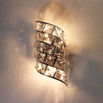 Decorative wall sconce with crystal accents on a neutral wall nz