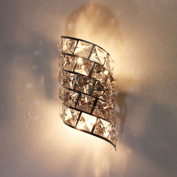 Decorative wall sconce with crystal accents on a neutral wall nz