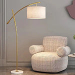 Gold floor lamp in a room with gray  walls nz
