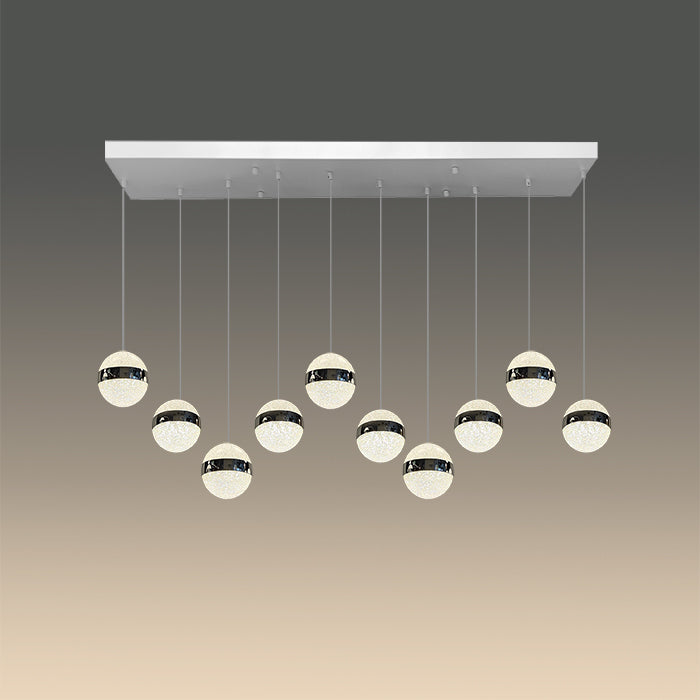 A modern LED pendant light with chrome finish and multiple round lamps hanging from a central bar nz