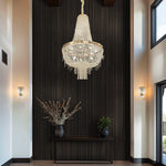 Luxurious chandelier hanging in a modern interior setting with decorative plants and wall lights nz