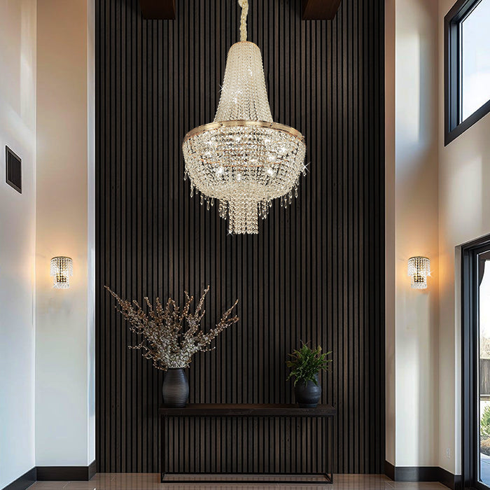 Luxurious chandelier hanging in a modern interior setting with decorative plants and wall lights nz