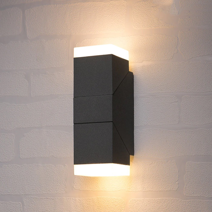 Modern black wall-mounted outdoor light fixture on a textured stone wall nz