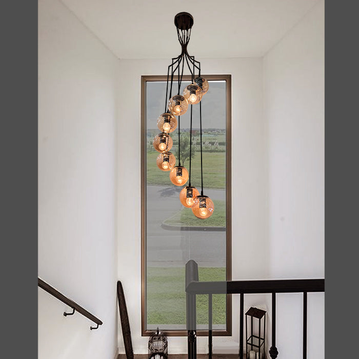 Modern chandelier hanging in a stairwell with a large mirror NZ
