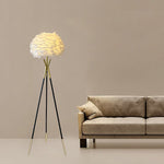 Modern tripod floor lamp with a beige lampshade in livingroom auckland