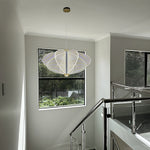 Modern interior with a chandelier hanging above a staircase nz
