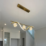Modern kitchen light fixture with three illuminated bulbs in a home interior nz