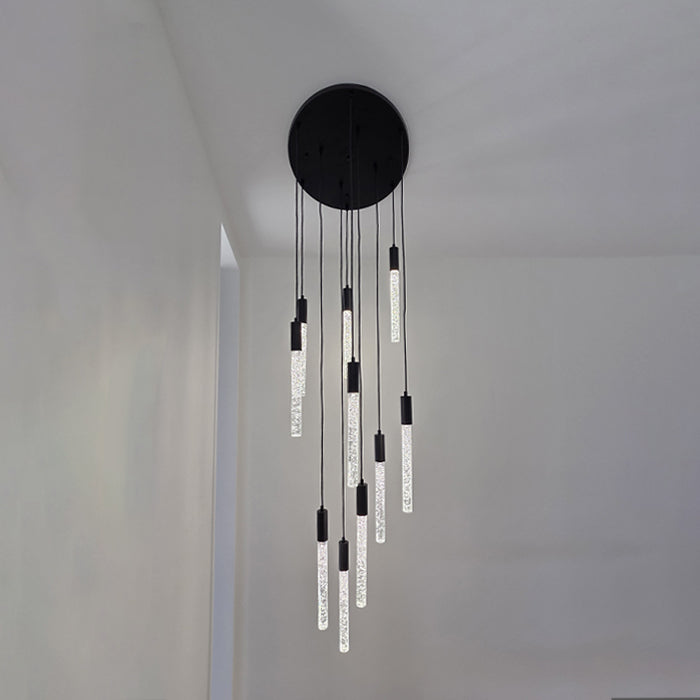 Modern pendant light fixture with black canopy and hanging cylindrical lights in a minimalistic setting auckland homes