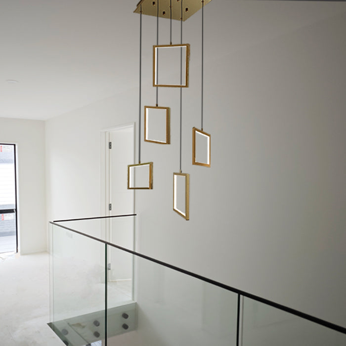 Modern pendant light fixture with gold frames hanging in the staircase area nz