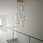 Modern pendant light fixture with gold frames hanging in the staircase area nz