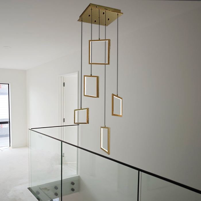 Modern pendant light fixture with gold frames hanging in the staircase area nz
