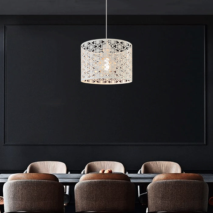 Modern pendant light hanging above a row of chairs in a dark room nz