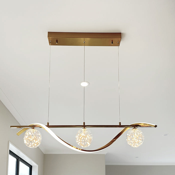 Modern pendant light fixture with three spherical glass shades  above kitchen island nz