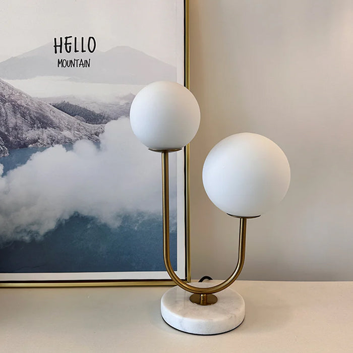 Modern table lamp with marble base and gold accents on the table auckland