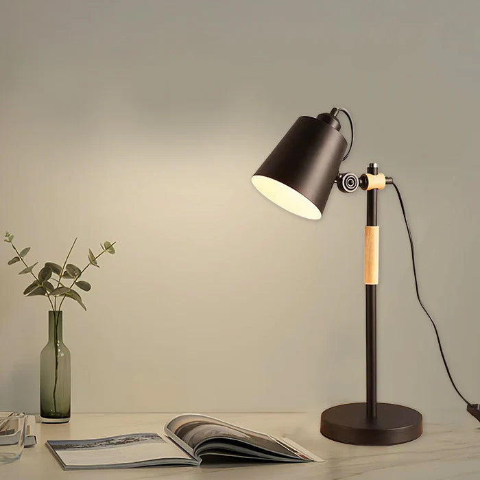 Modern table lamp on a desk with a magazine and vase in a warm setting nz