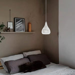 Pendant light hanging above a bed in a bedroom west auckland