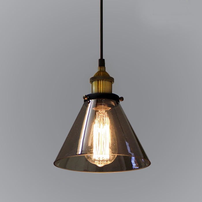 A vintage-style pendant light with smoke glass shade and brass finish suspension
