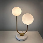Table lamp with two round glass shades on the table west auckland