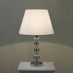 Table lamp with a white shade and crystal base on the table nz