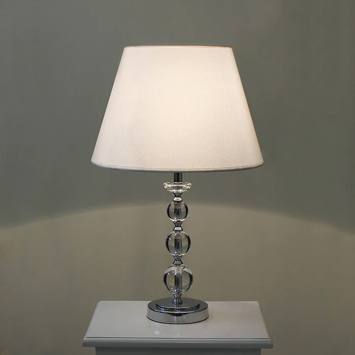 Table lamp with a white shade and crystal base on the table nz