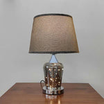 Table lamp with a textured brown shade on the table nz