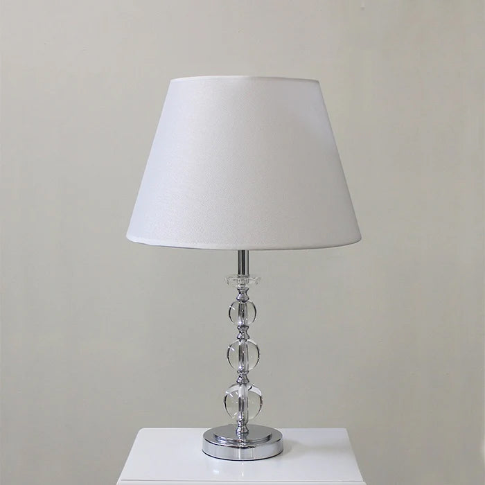 Table lamp with a white shade and crystal base on a white surface west auckland