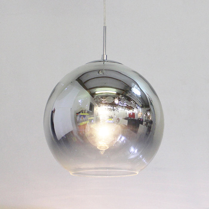 Vintage-style glass pendant light with mirror-reflective glass above table nz