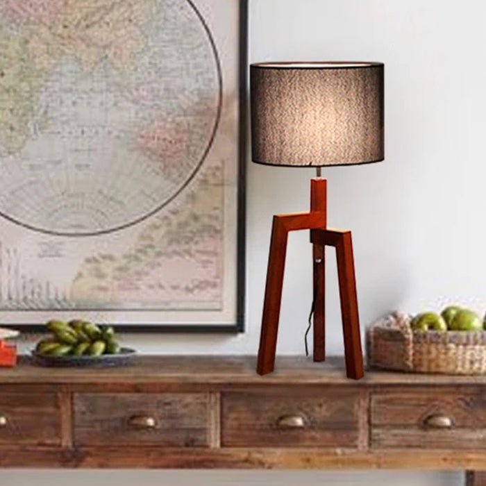 Wooden table lamp with a dark shade on a wooden surface nz