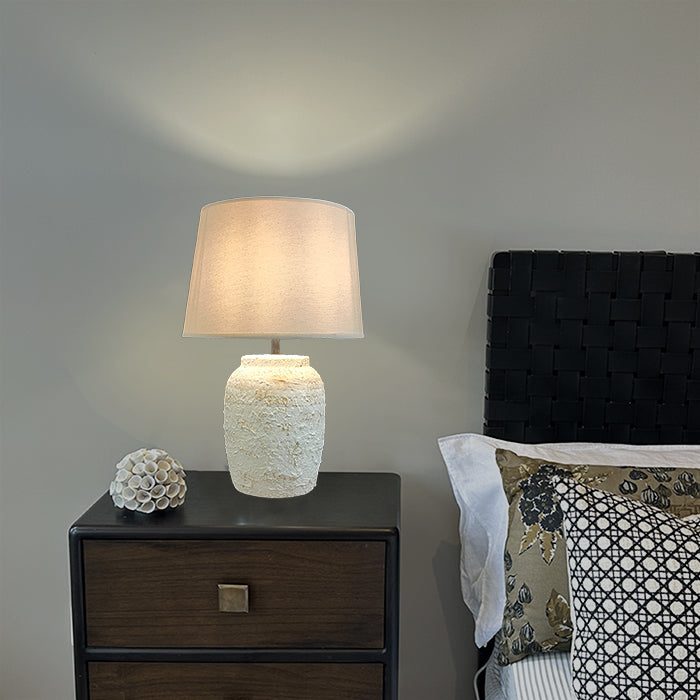 Lamp on a nightstand with decorative pillows auckland