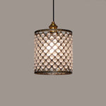 A cylindrical lampshade with a geometric pattern of clear crystals set in a brown metal frame nz