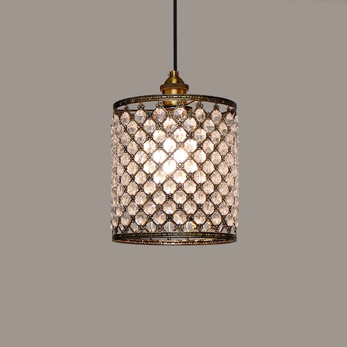 A cylindrical lampshade with a geometric pattern of clear crystals set in a brown metal frame nz