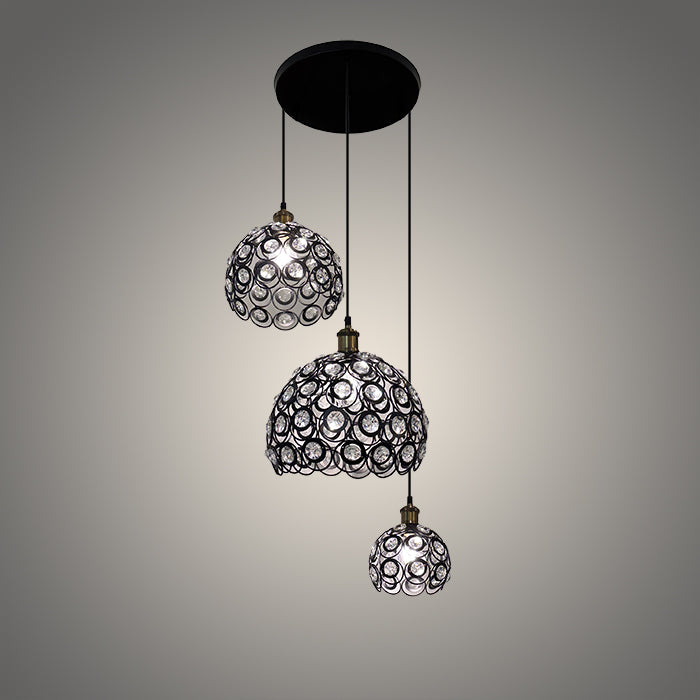 Three hanging pendant lights with decorative glass shades 