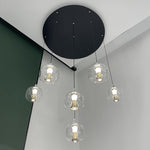 Modern pendant light fixture with clear glass shades in living room nz