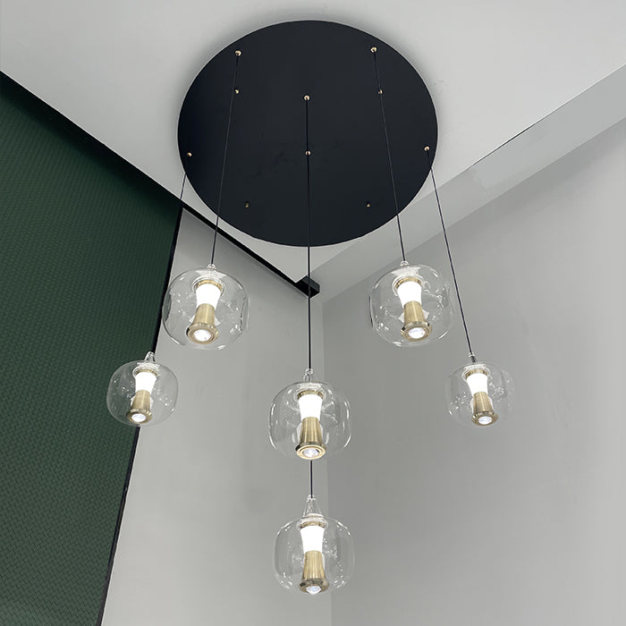 Modern pendant light fixture with clear glass shades in living room nz