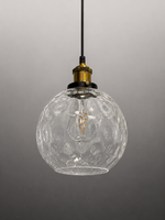 A clear textured glass globe pendant light with a black hanging cord and a brass-colored socket, shown against a neutral gray gradient background.