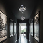 Dark hallway with framed pictures ochandeliers hanging from the ceiling auckalnd