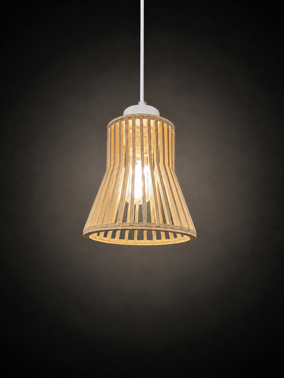 A hanging pendant light with a conical shade made of natural bamboo or rattan slats, suspended from a white cord against a dark gray background.