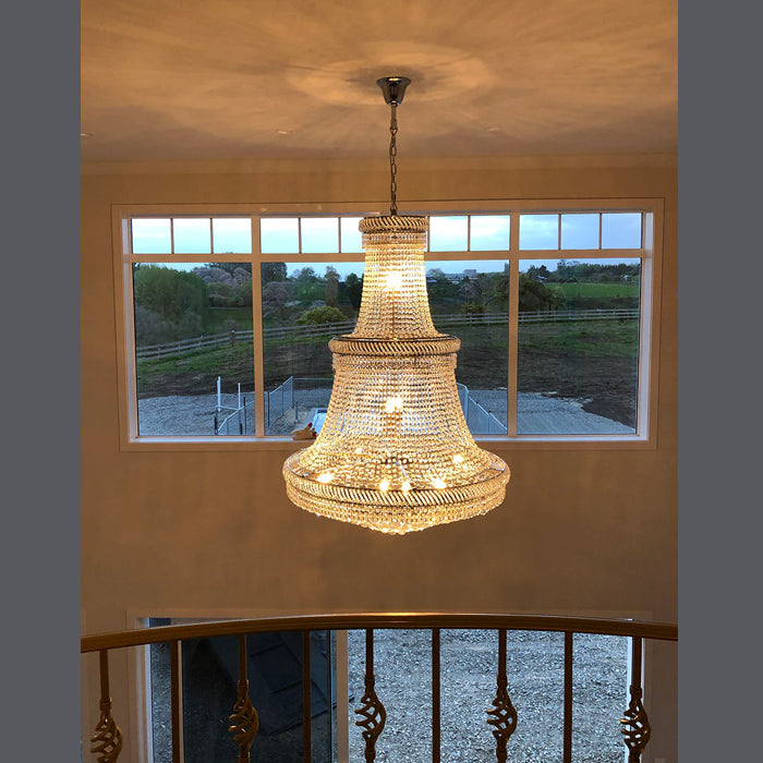 Chandelier hanging in a room with a large window view nz
