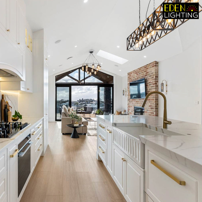 A black metal frame pendant light with multiple bulbs hanging above island nz