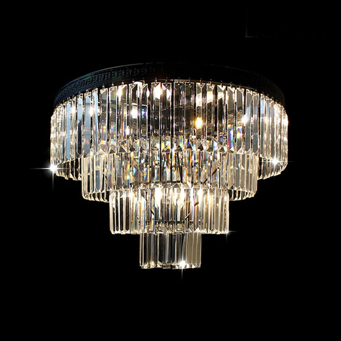 A modern black chandelier with clear crystal tiers hanging on the staircase area